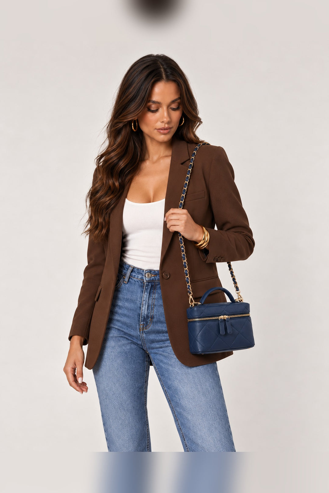 Navy Snow crossbody worn on the shoulder by its chain strap