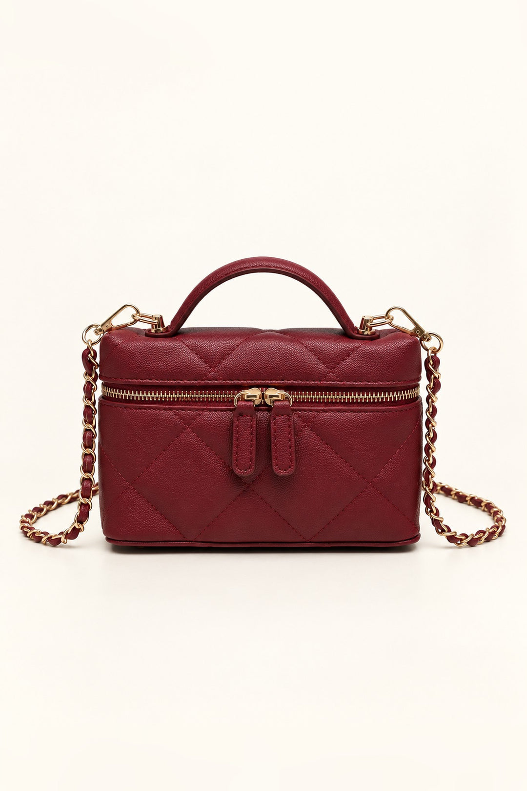 Burgundy diamond-quilted Snow crossbody with gold zip and curved top handle