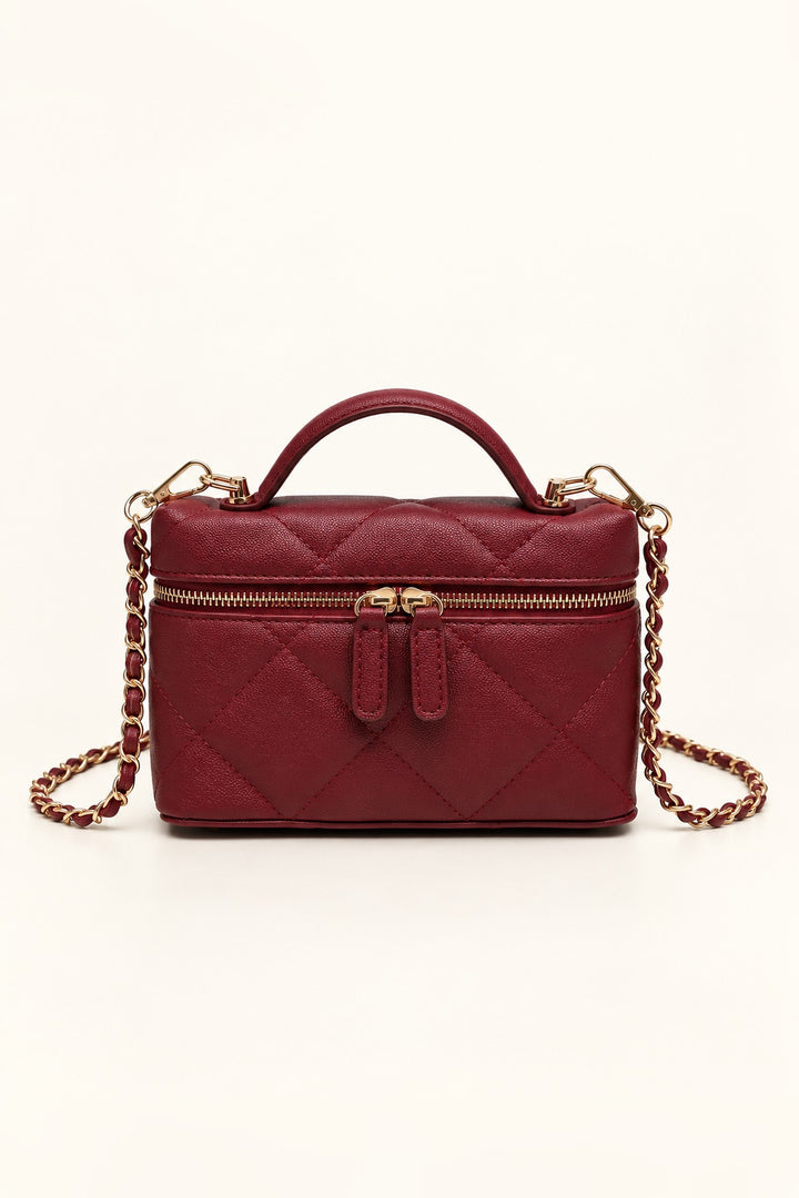 Burgundy diamond-quilted Snow crossbody with gold zip and curved top handle