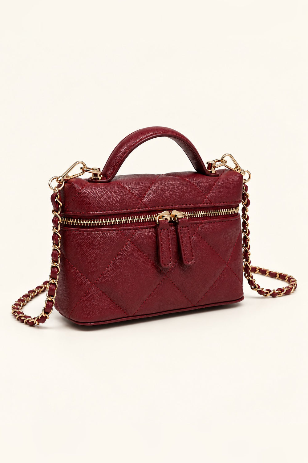 Burgundy quilted crossbody at an angle showing its compact structured shape