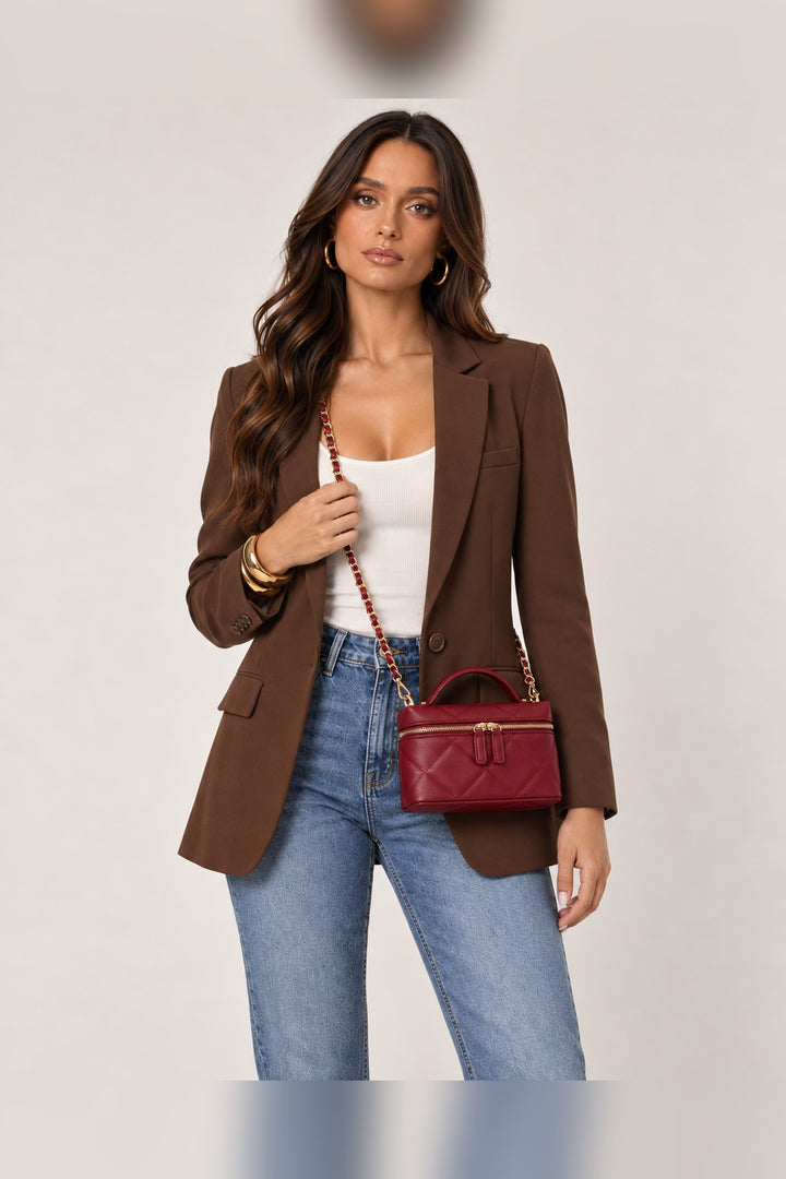 Burgundy Snow crossbody worn on the shoulder by its chain strap