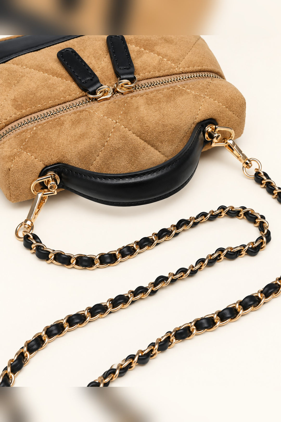 Close detail of the suede-look quilting and gold zip pulls on the Novalee crossbody