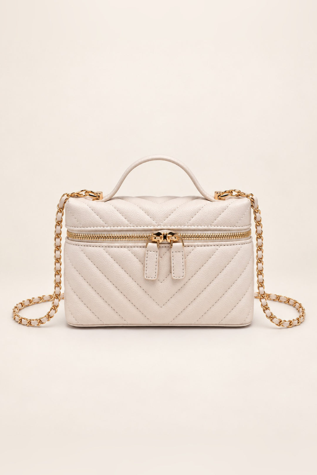 Ivory chevron-quilted Sella crossbody with gold two-way zip and top handle