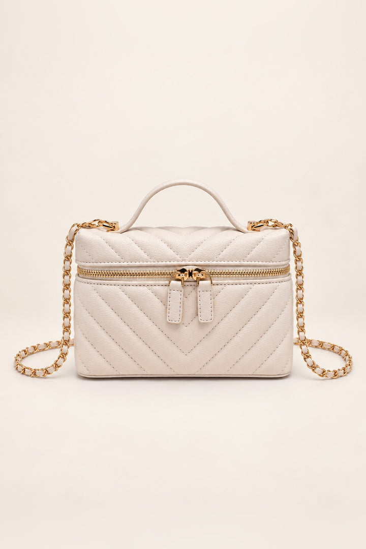 Ivory chevron-quilted Sella crossbody with gold two-way zip and top handle