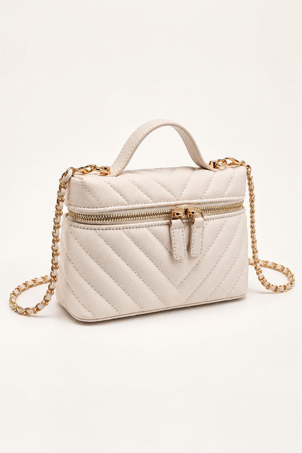 Ivory chevron-quilted crossbody at an angle showing its compact structured shape