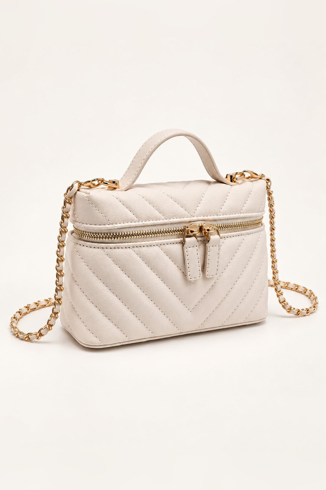 Ivory chevron-quilted crossbody at an angle showing its compact structured shape