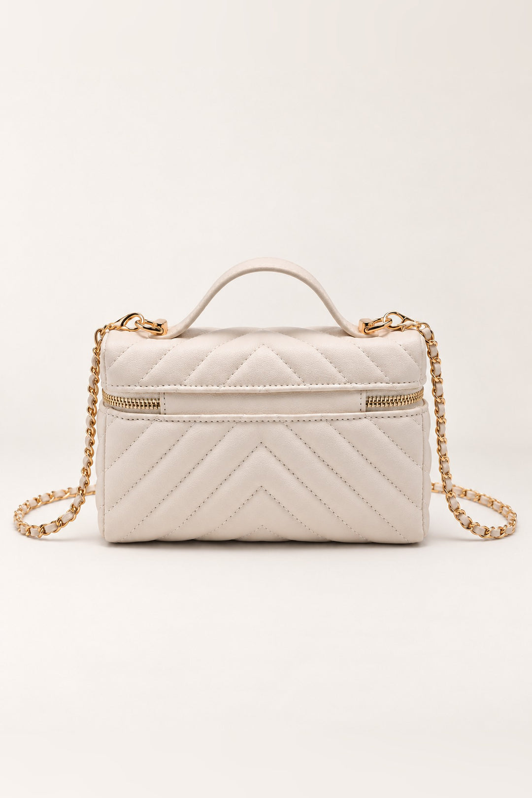 Back of the ivory chevron-quilted Sella crossbody in pebbled vegan leather