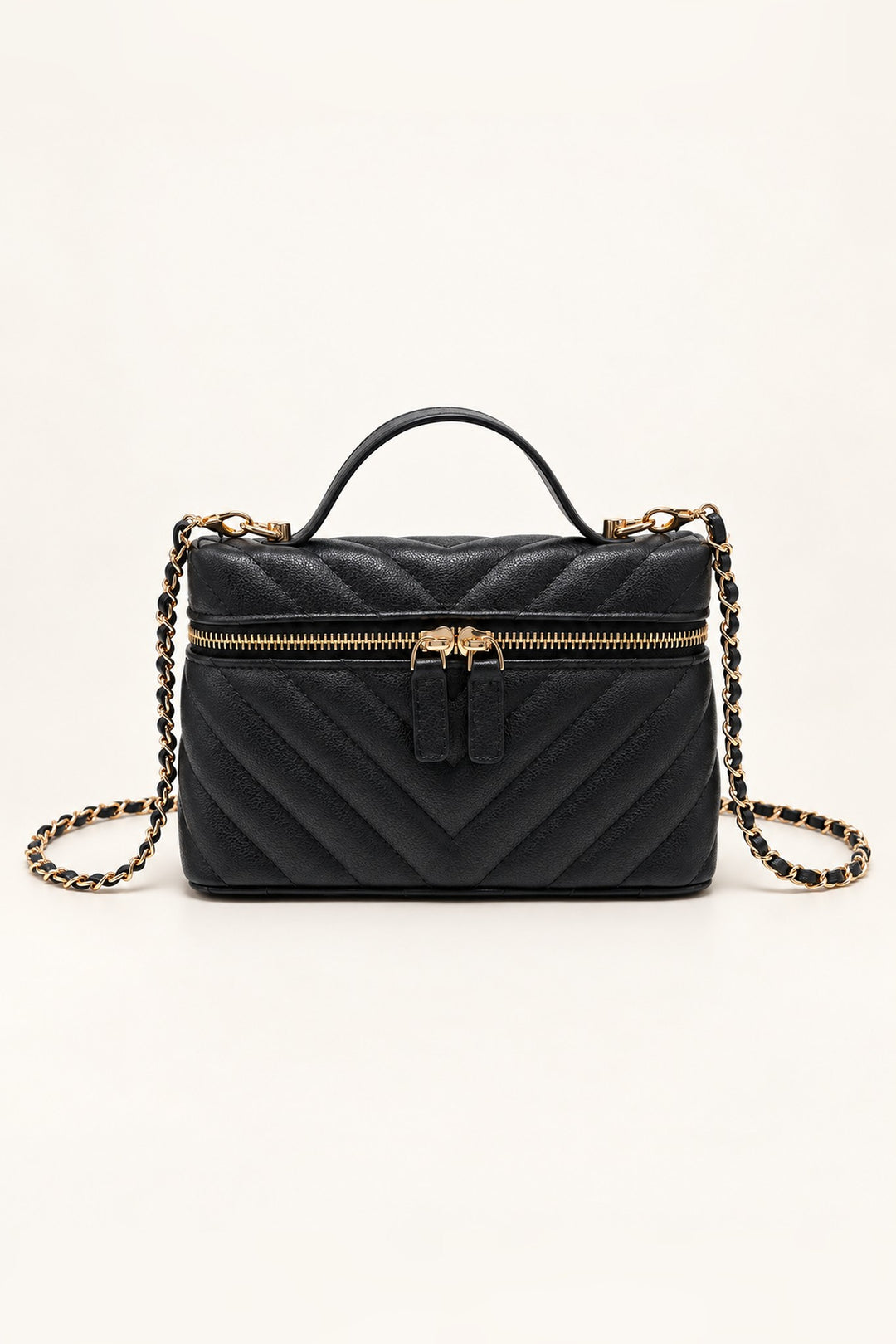 Black chevron-quilted Sella crossbody with gold two-way zip and top handle