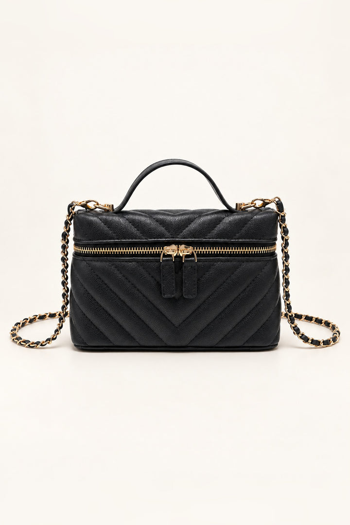Black chevron-quilted Sella crossbody with gold two-way zip and top handle