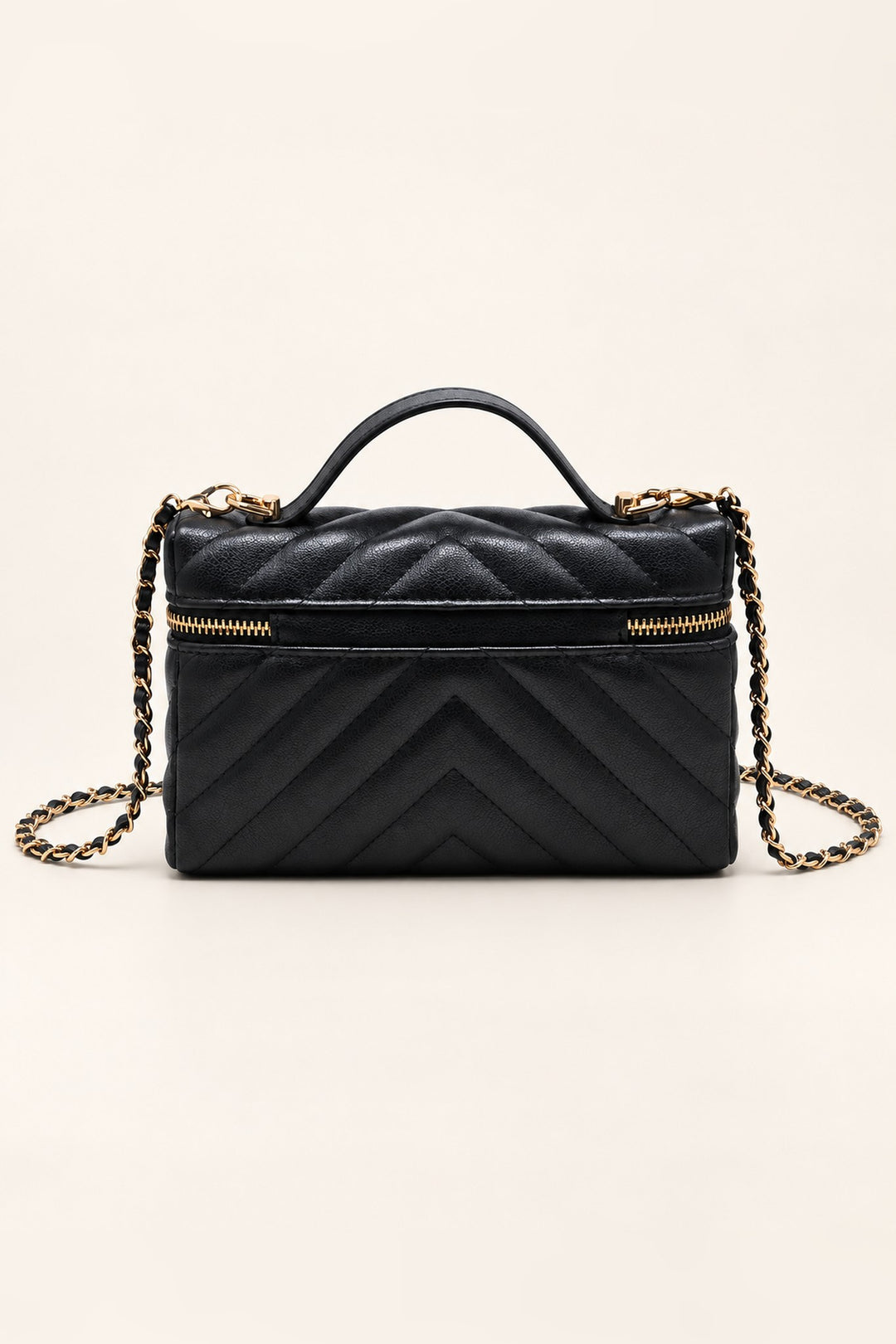 Back of the black chevron-quilted Sella crossbody in pebbled vegan leather