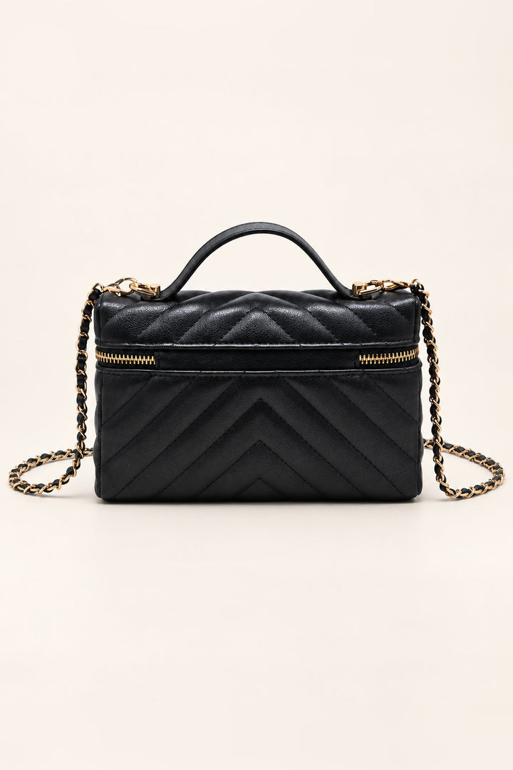 Back of the black chevron-quilted Sella crossbody in pebbled vegan leather