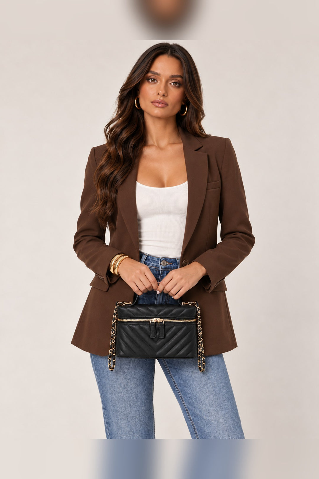 Black chevron-quilted crossbody carried by its top handle