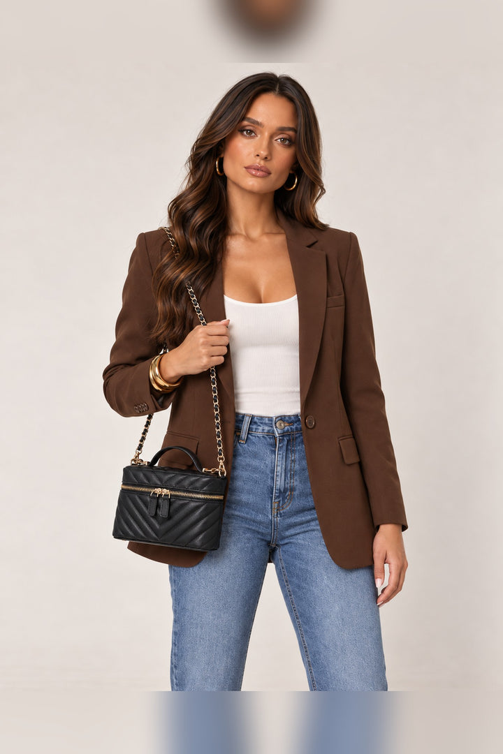 Black Sella crossbody worn on the shoulder by its woven chain strap