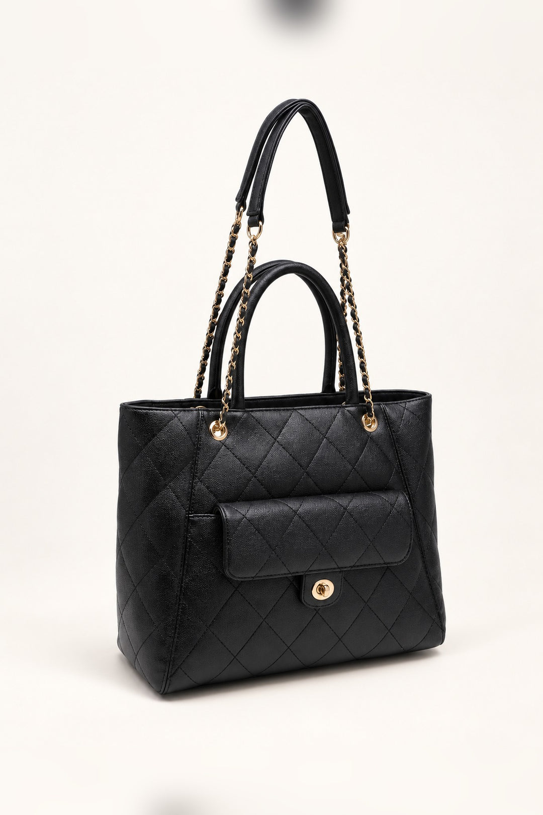 Black quilted tote at an angle showing its roomy structured silhouette
