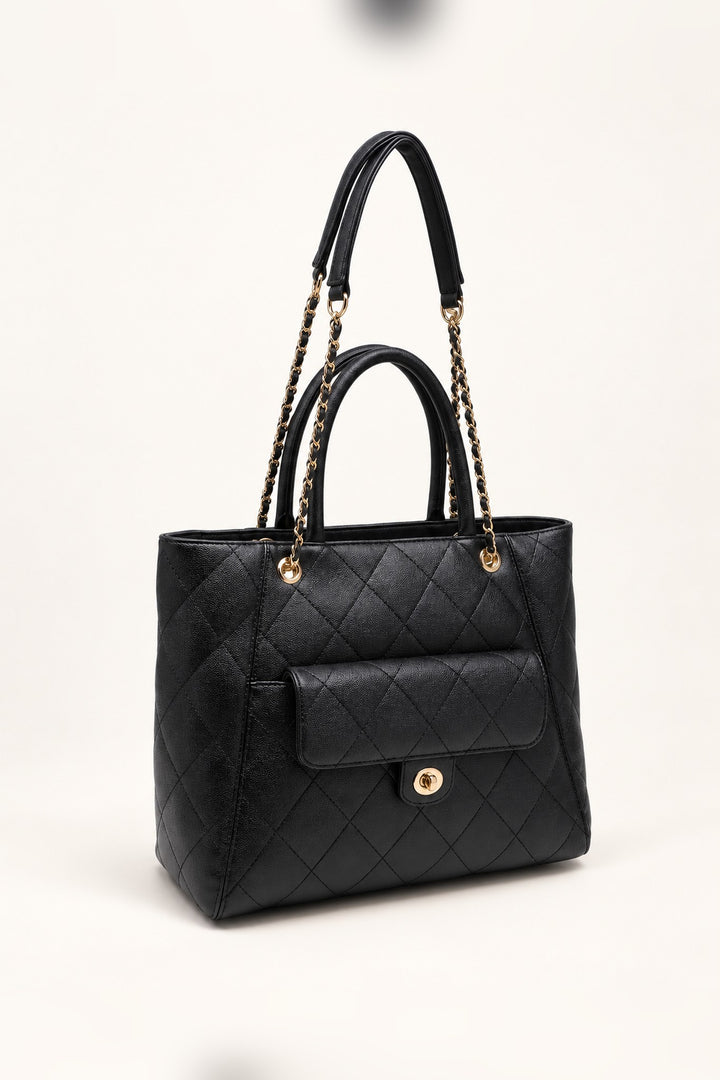Black quilted tote at an angle showing its roomy structured silhouette