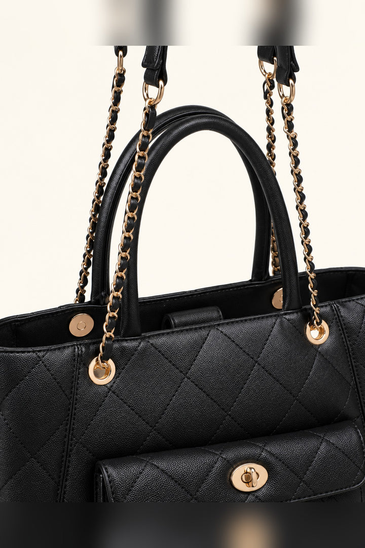 Close detail of the diamond quilting and gold turn-lock clasp on the black Hank tote