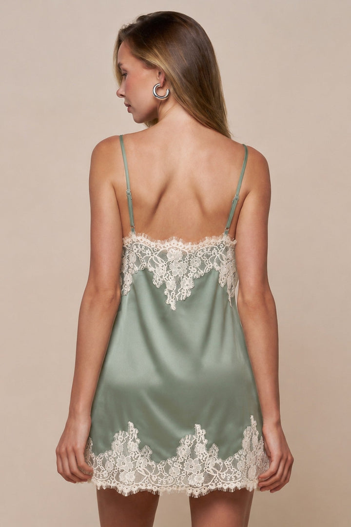 Back view of Blue Blush sage satin mini dress with cream lace trim