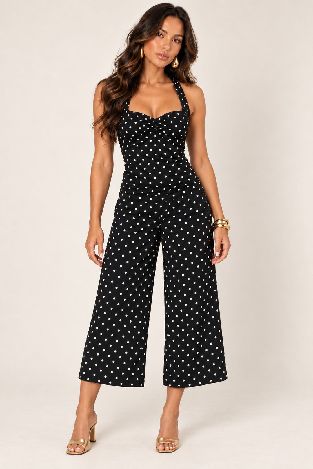 Black off-white polka dot wide-leg crop pants worn with the matching halter top, front view