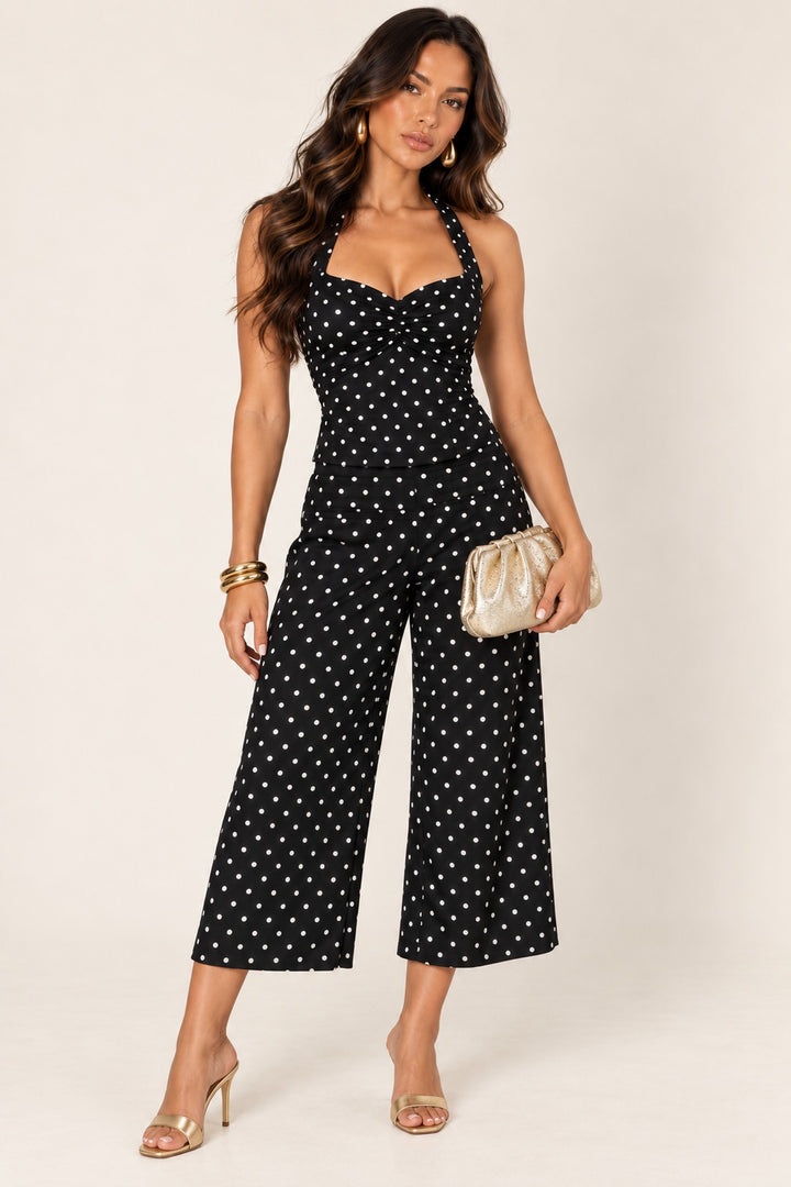 Black polka dot halter top and crop pants styled with the Gold Fancy Metallic Ruched Clutch