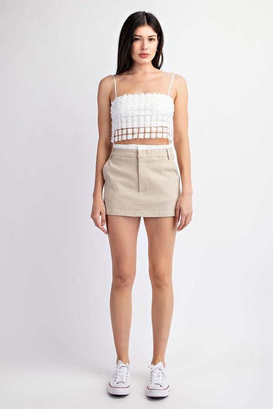 model is wearing Beige White Striped Contrast Skort with white shimmer top and white sneakers