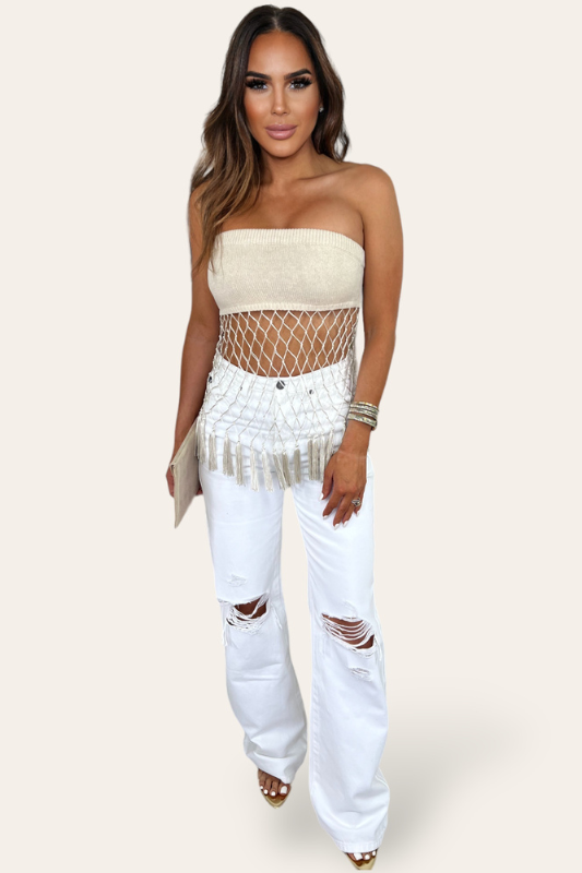 model is wearing Natural Crochet Tassel Tube Top with white denim pants and gold heels 