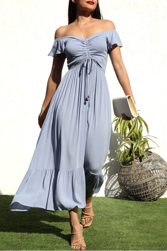 model is wearing Blue Smocked Long Dress with beige heel sandals and ivory clutch 