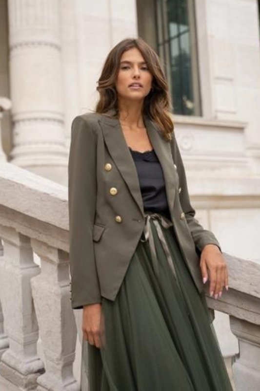 model is wearing Khaki Fitted Blazer Jacket with a black silk top under and a green maxi skirt 