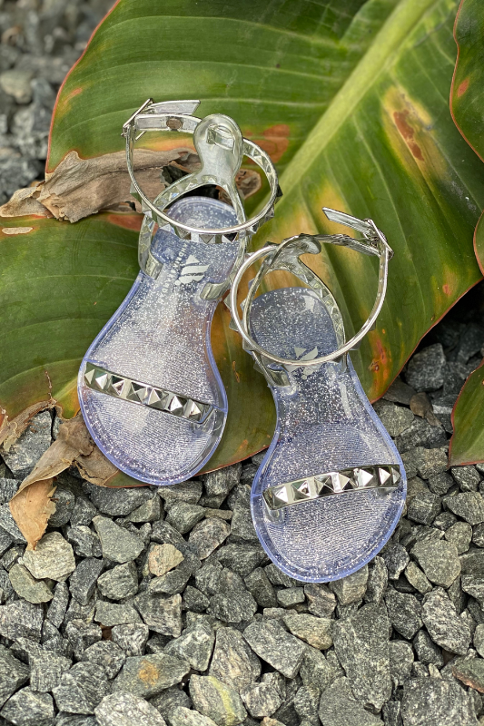 Aria Kids silver jelly sandals with thin strap across the toes and thin ankle strap, these sandals are perfect for beach or pool days, you can wear them with a casual chic look