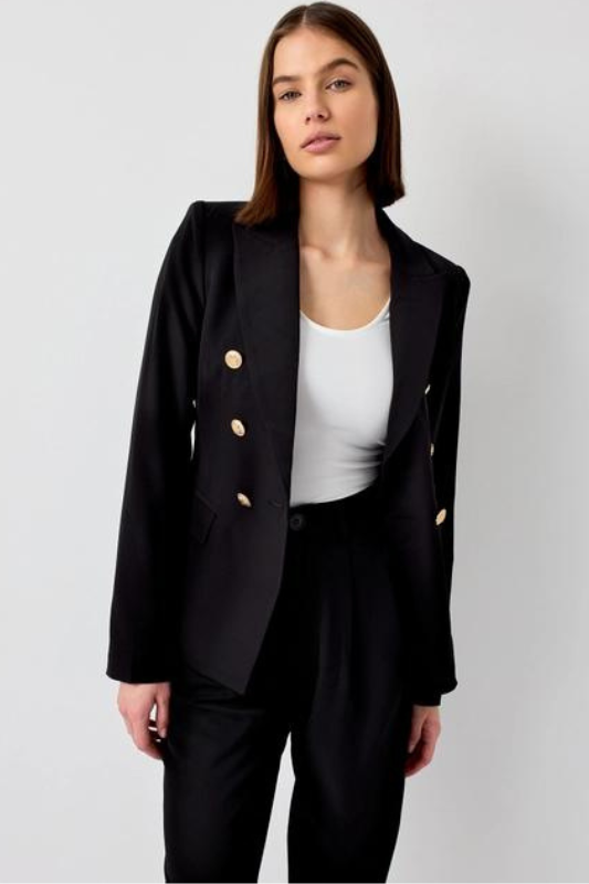 model is wearing the Black Fitted Blazer Jacket  with a white top and matching black pants