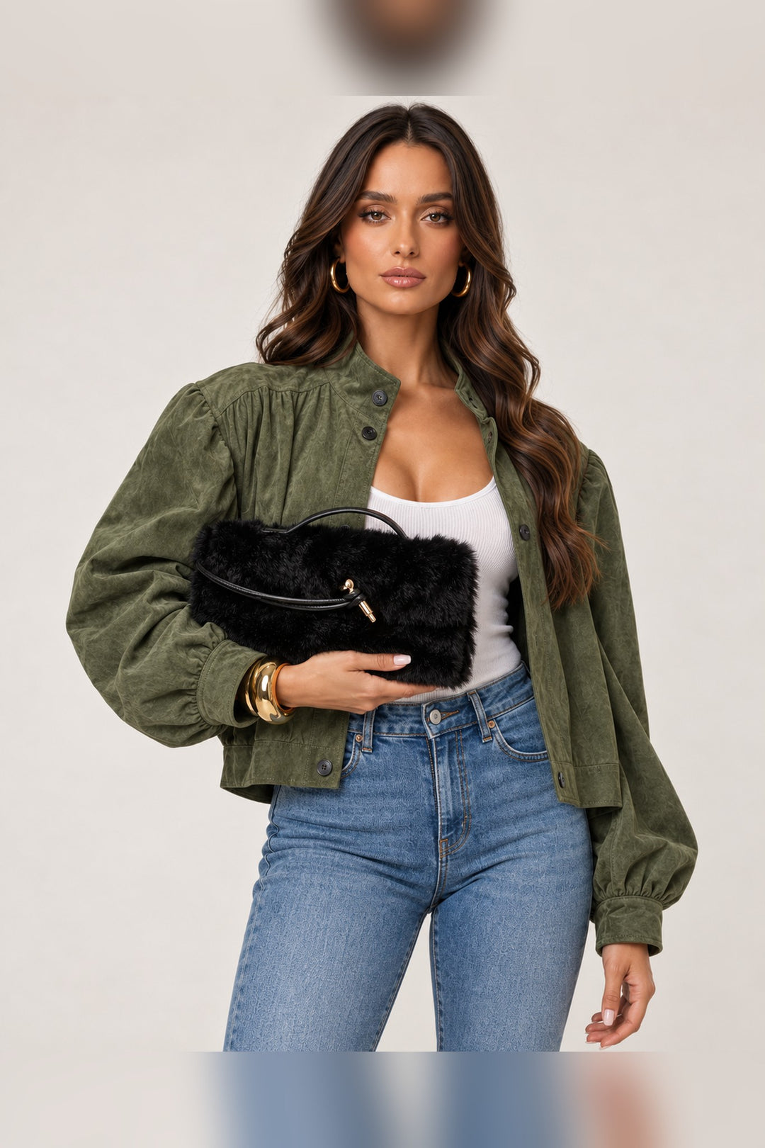 Model holding the black Ada faux fur handbag in front, a holiday party accessory