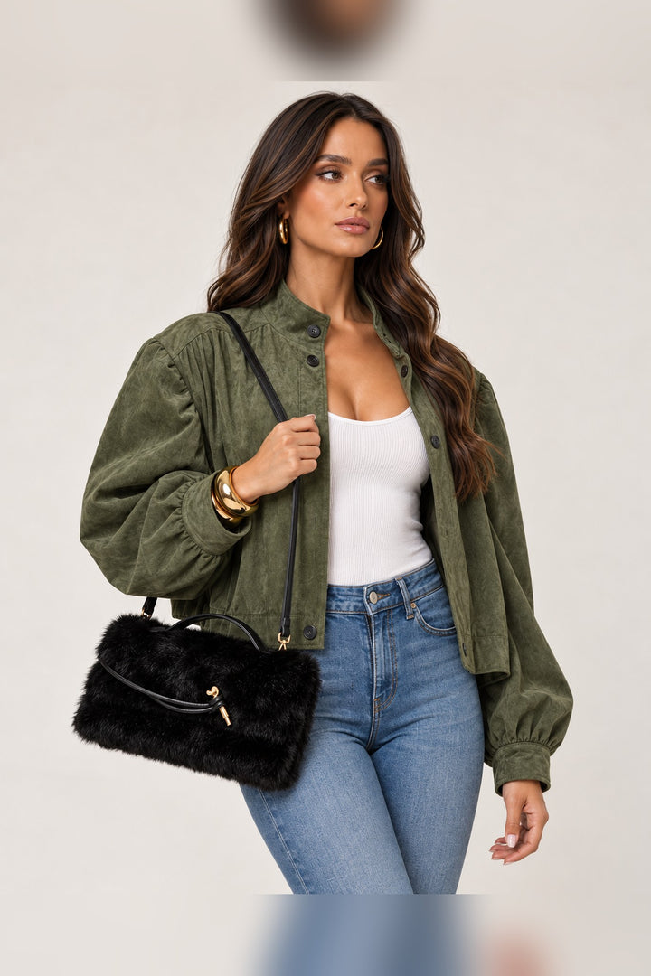 Close view of the black faux fur Ada bag worn on the shoulder with adjustable strap