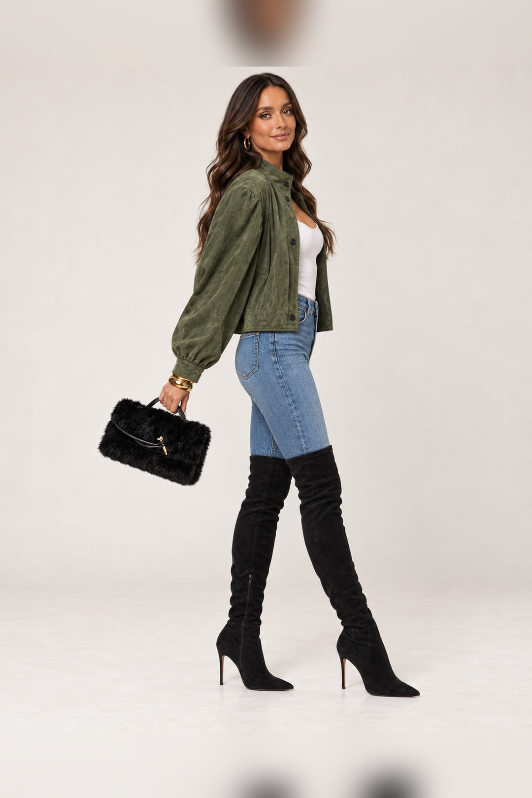 Side view of the black Ada faux fur bag carried by its top handle, a Thanksgiving outfit accessory