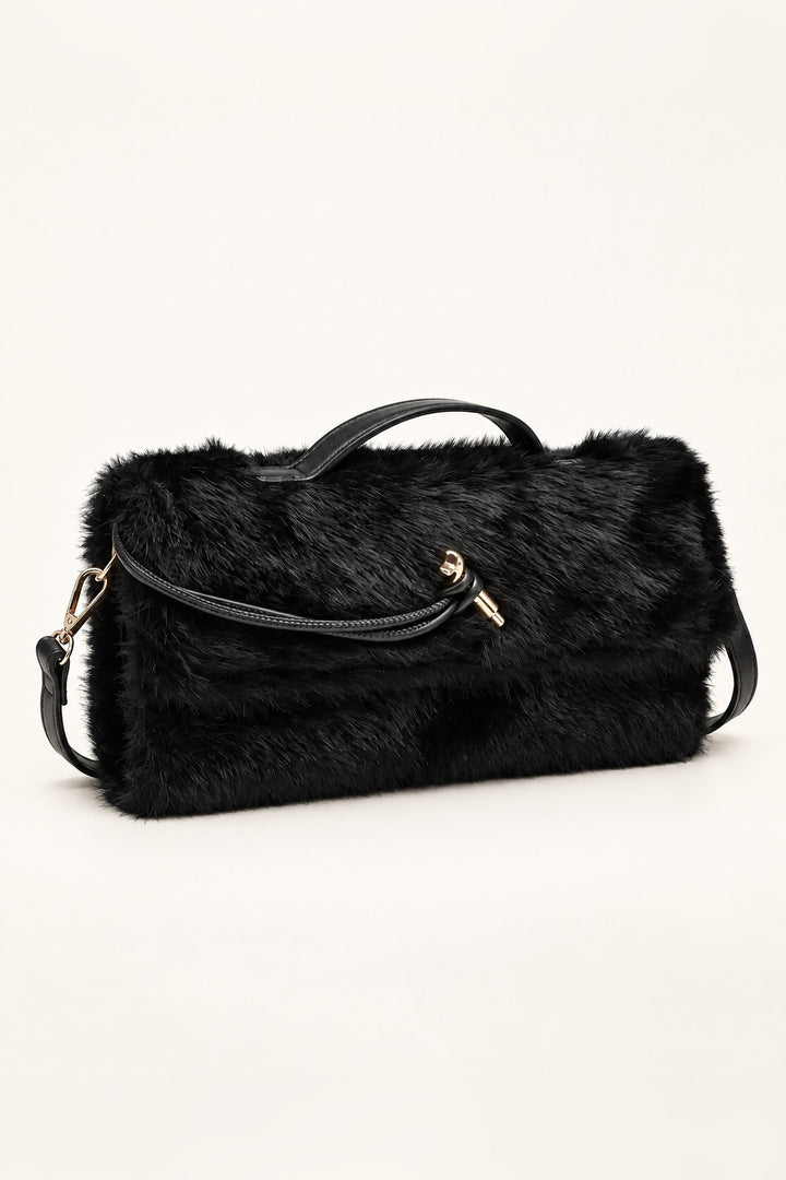 Angled view of the black Ada faux fur crossbody bag with fold-over flap