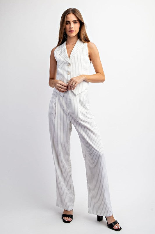 model is wearing White Stripe Collar Vest with matching pants with black heels 
