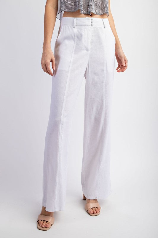 model is wearing Off White Stretch Linen Tailored Trousers with beige heel sandals 