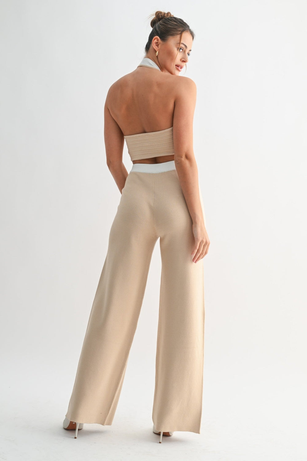 Contrast trim edging the beige halter vest neckline