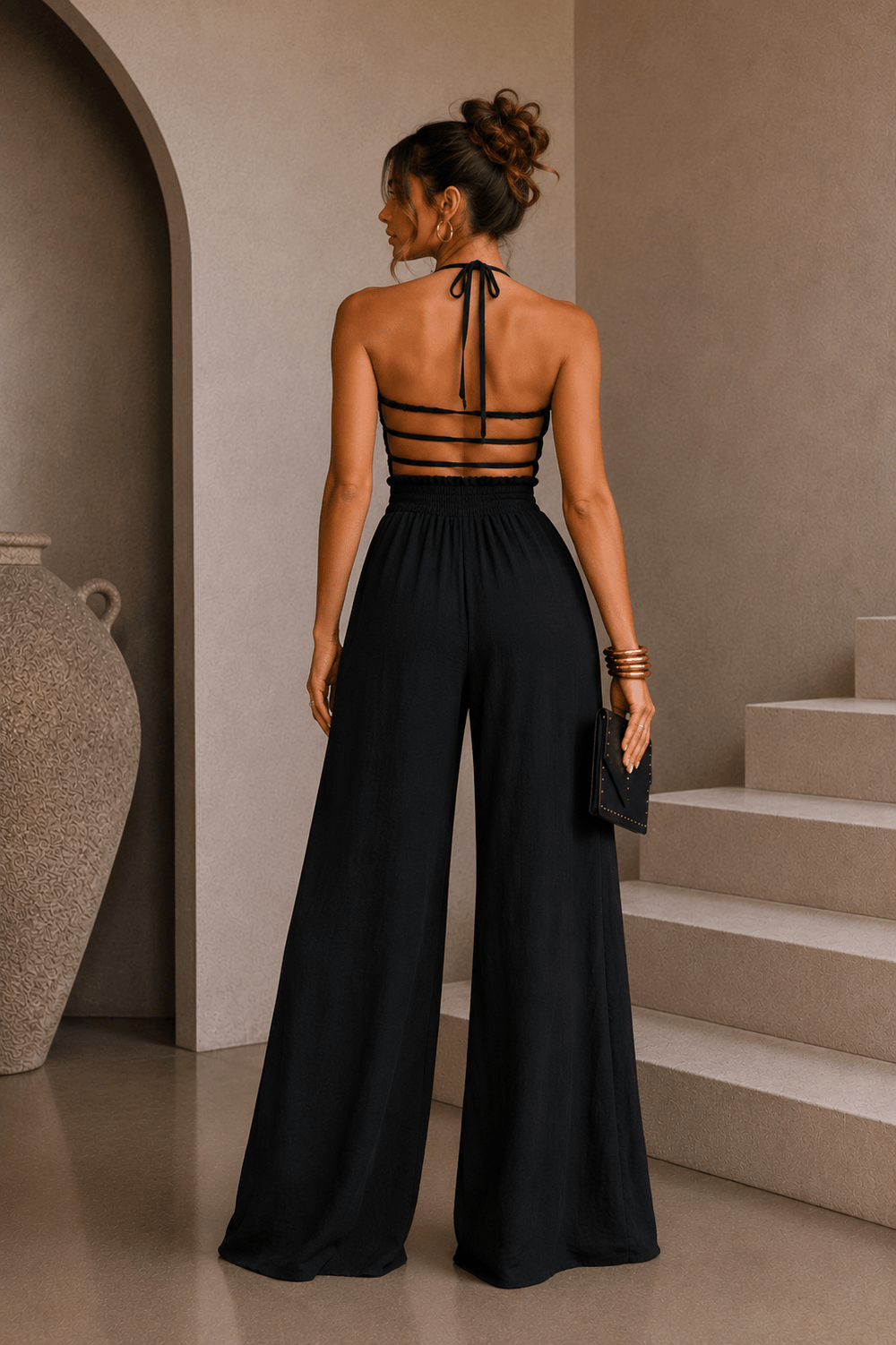 Strappy open-back detailing on a black wide leg jumpsuit