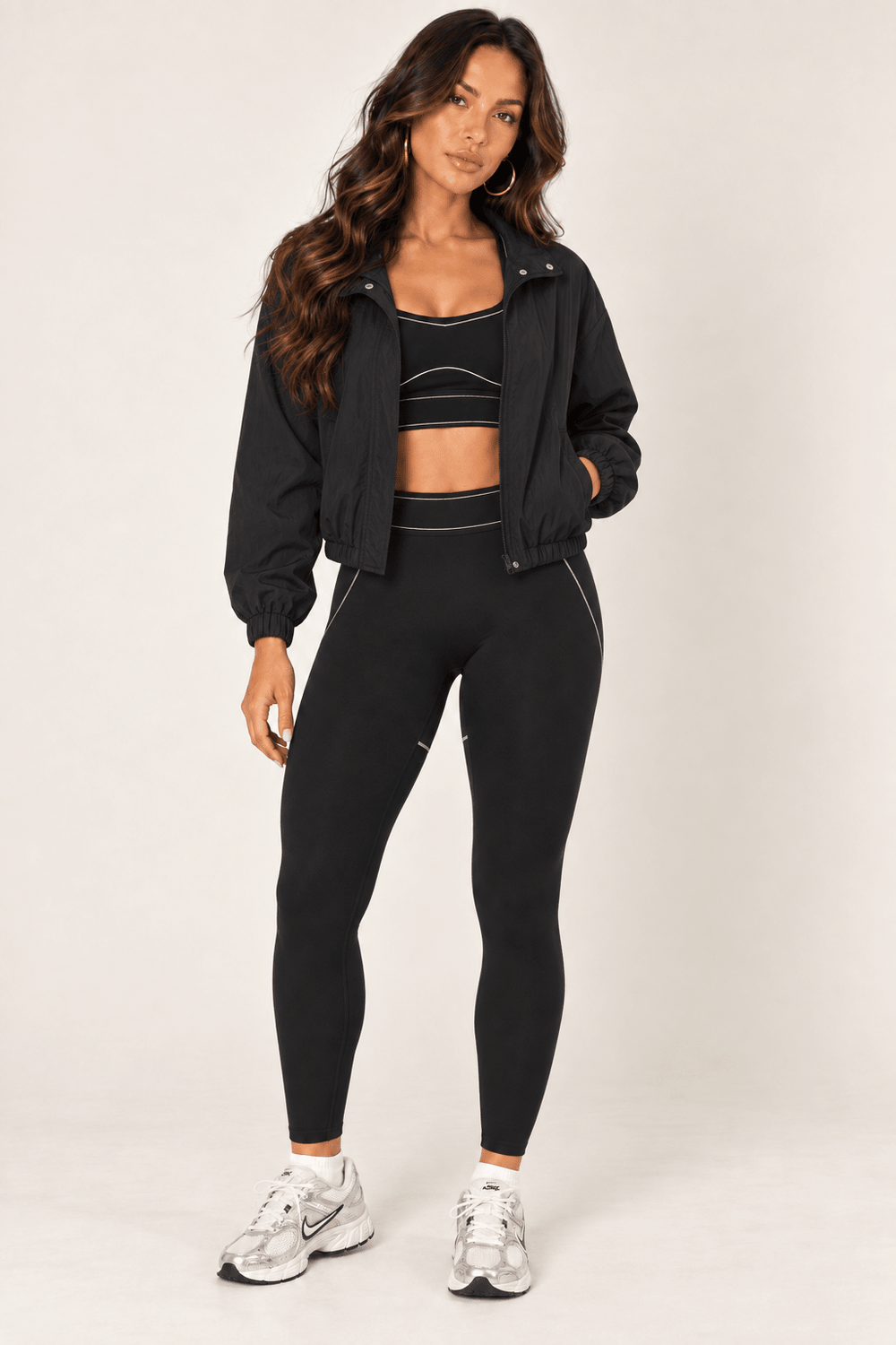 Concealed zip detail on a black cropped nylon windbreaker