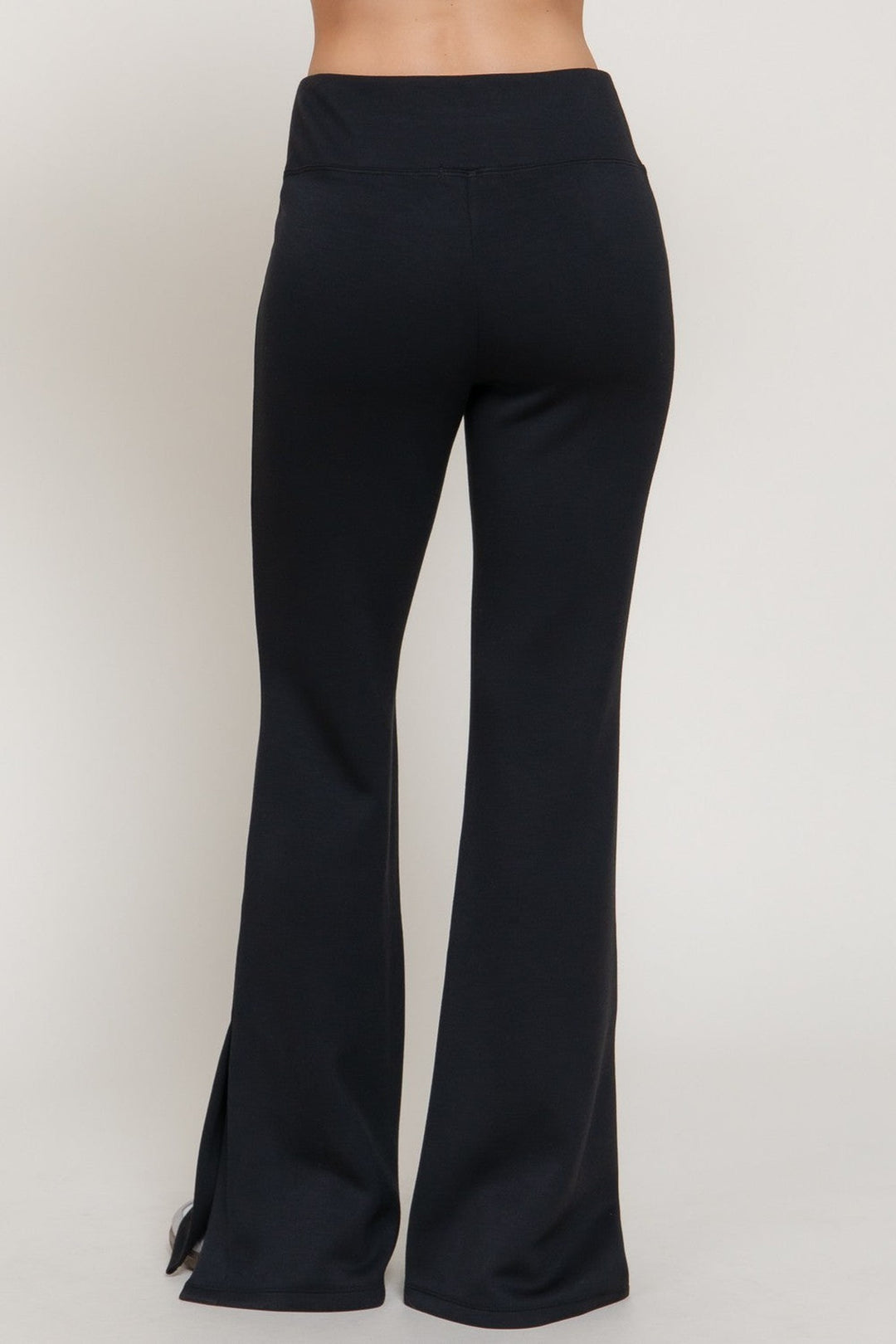 Black flare pants with slit hems, back view
