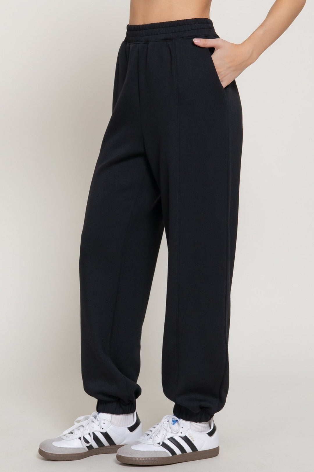 Black soft scuba flare pants, side view
