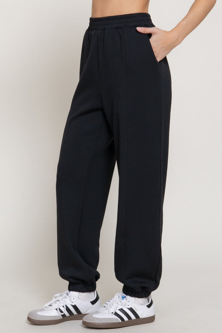 Black soft scuba flare pants, side view
