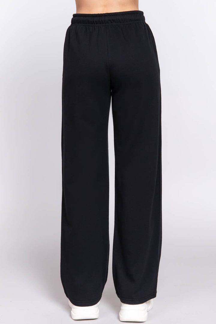 Back view of the black fleece joggers with straight leg hem, a Thanksgiving travel outfit