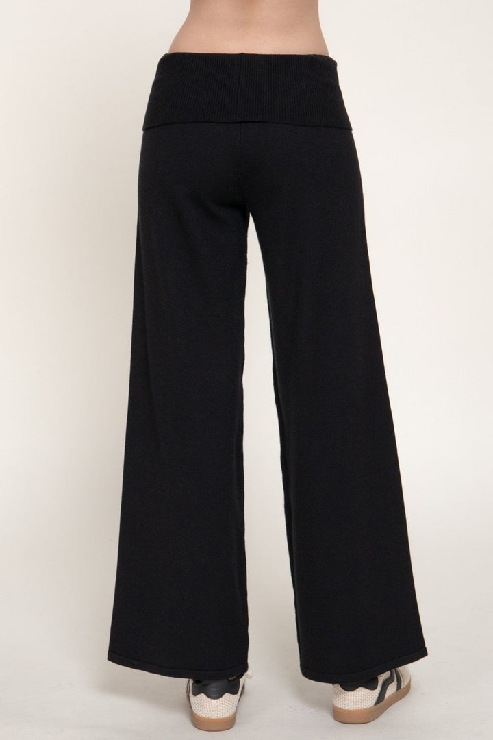 Back view of the black fold over waist sweater pants with wide leg hem