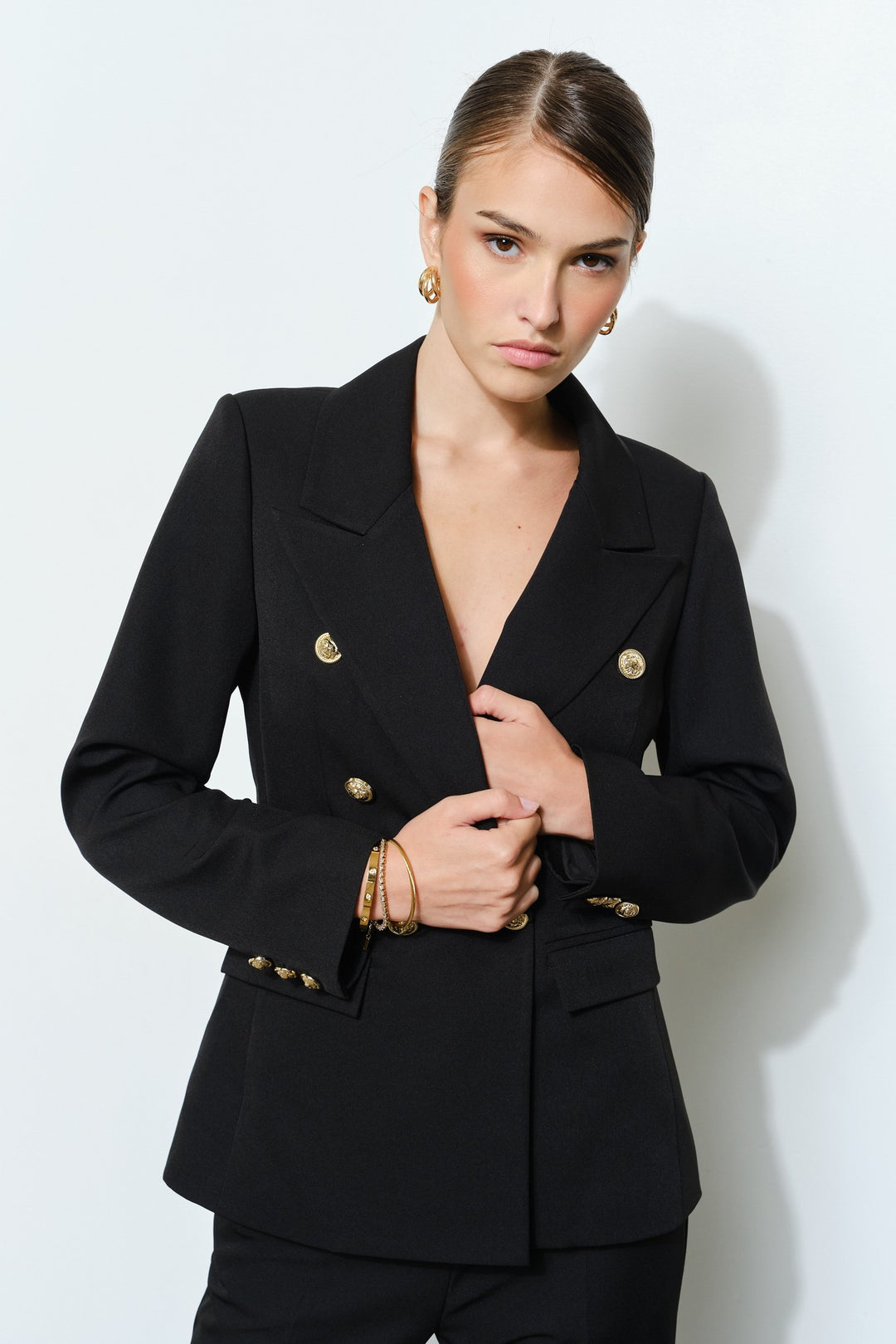 Close up of the gold buttons on the black double breasted blazer