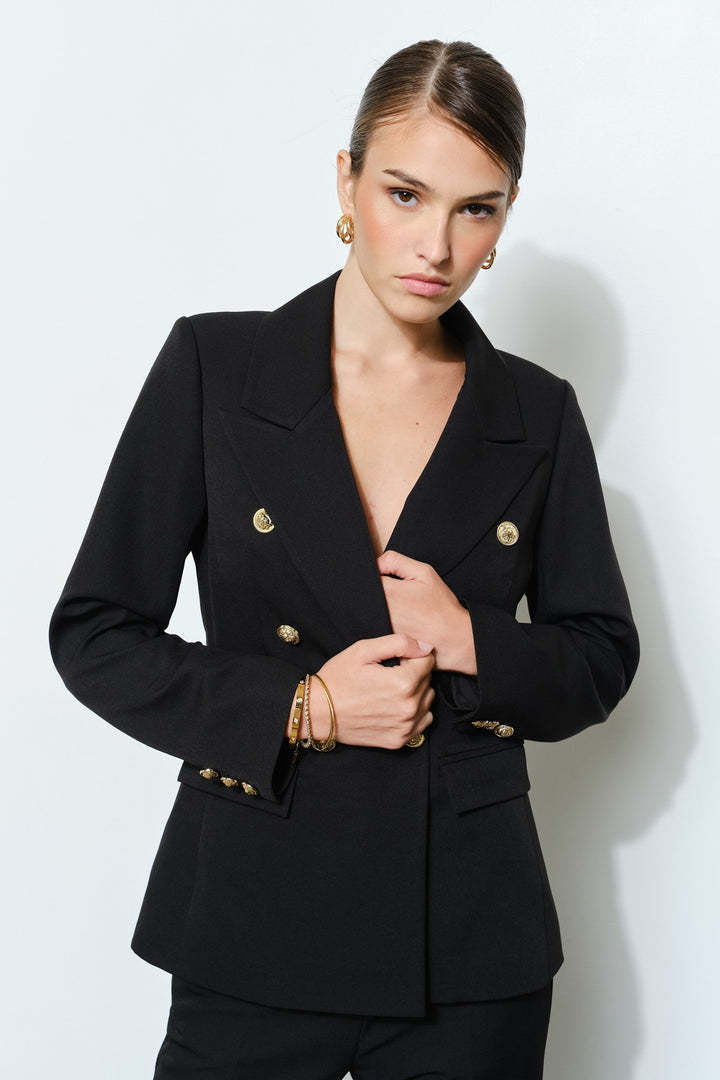 Close up of the gold buttons on the black double breasted blazer