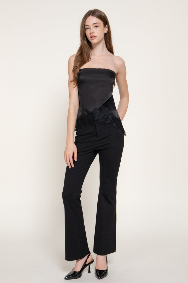 Black lace trim satin tube top worn with black pants, front view