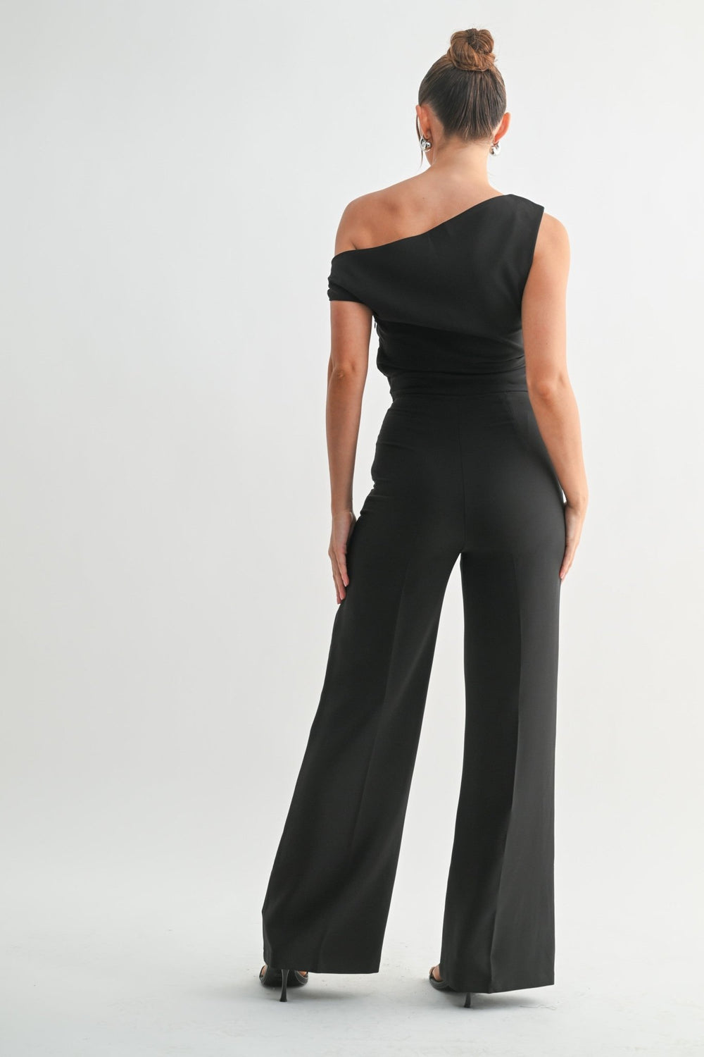 Structured black jumpsuit tailored through the waist for formal events