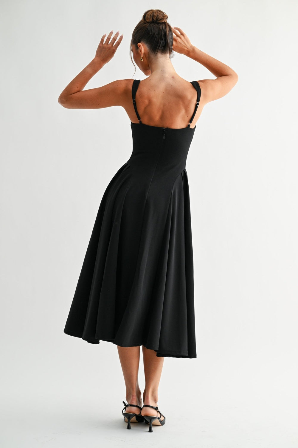 Black midi dress with a discreet back zipper and softly flared skirt
