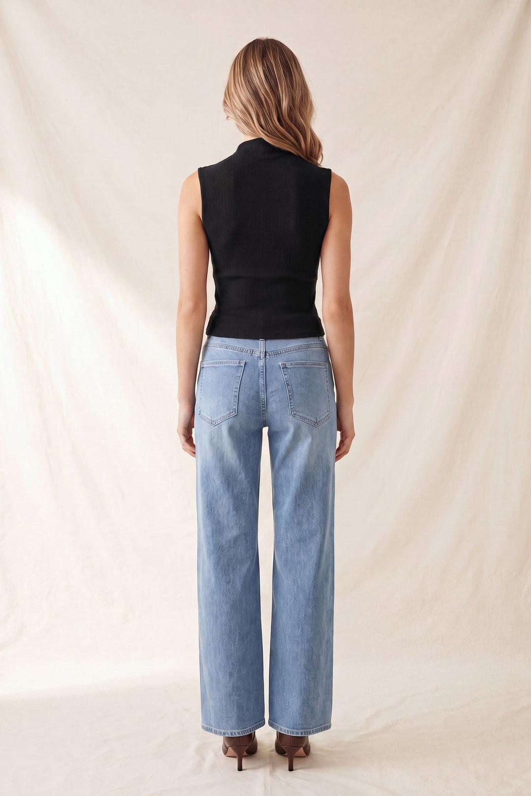 Black sleeveless mock neck top, back view
