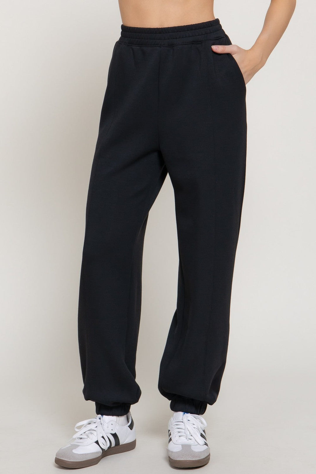 Black pintuck soft scuba jogger pants with elastic waist and cuffed hem, front view